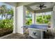 Outdoor recreation area featuring a ping pong table with surrounding lush greenery and elegant columns at 11140 Hogan Cir, Englewood, FL 34223