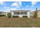Front view of a white single-wide home at 115 White Oak Way, Sarasota, FL 34237