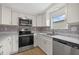 Updated kitchen, white cabinets, stainless steel appliances at 115 White Oak Way, Sarasota, FL 34237
