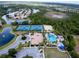 Aerial view showing community pool, tennis courts, and clubhouse at 11692 Spotted Margay Ave, Venice, FL 34292