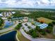 Aerial view of community amenities including tennis courts and pool at 11692 Spotted Margay Ave, Venice, FL 34292