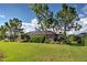 Backyard view of a house with a screened patio and landscaping at 11692 Spotted Margay Ave, Venice, FL 34292