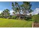 Landscaped backyard with screened patio and mature trees at 11692 Spotted Margay Ave, Venice, FL 34292