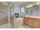 Double vanity, soaking tub, and walk-in shower in this elegant bathroom at 11692 Spotted Margay Ave, Venice, FL 34292
