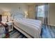 Bedroom with striped bedding, wood-look flooring, and a TV at 11692 Spotted Margay Ave, Venice, FL 34292