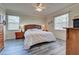 Spacious bedroom with king-size bed, wood furniture, and large windows at 11692 Spotted Margay Ave, Venice, FL 34292