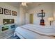 Bedroom with ceiling fan, striped bedding and wood-look flooring at 11692 Spotted Margay Ave, Venice, FL 34292