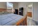 Bedroom with wood framed bed and ensuite bathroom at 11692 Spotted Margay Ave, Venice, FL 34292