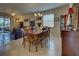 Bright dining room features a wooden table with six chairs, hardwood floors, and decorative accents at 11692 Spotted Margay Ave, Venice, FL 34292