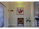 Entryway with artwork, decorative console table and floor tile at 11692 Spotted Margay Ave, Venice, FL 34292