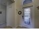 Entryway with coat closet and decorative mirror at 11692 Spotted Margay Ave, Venice, FL 34292