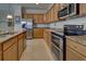 Well-equipped kitchen featuring stainless steel appliances and granite countertops at 11692 Spotted Margay Ave, Venice, FL 34292