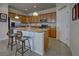 Kitchen with island, stainless steel appliances, and wood cabinets at 11692 Spotted Margay Ave, Venice, FL 34292