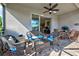 Relaxing screened lanai with wicker furniture and ceiling fan at 11692 Spotted Margay Ave, Venice, FL 34292