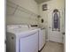 Laundry room with washer, dryer and shelving at 11692 Spotted Margay Ave, Venice, FL 34292