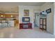 Living area with a kitchen and bedroom view, fireplace, and tiled floors at 11692 Spotted Margay Ave, Venice, FL 34292