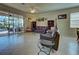 Living room with leather couches, glass table, and view of the pool at 11692 Spotted Margay Ave, Venice, FL 34292