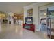 Open living space with kitchen, bedroom, fireplace, and tiled floors at 11692 Spotted Margay Ave, Venice, FL 34292