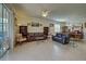 Comfortable living room with leather seating, tiled floor, and access to patio at 11692 Spotted Margay Ave, Venice, FL 34292