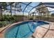 Enclosed pool and spa with brick pavers at 11692 Spotted Margay Ave, Venice, FL 34292