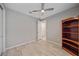 Bright bedroom with wood-look tile floors and a ceiling fan at 12029 Tapestry Ln, Venice, FL 34293