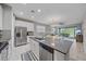Modern kitchen featuring stainless steel appliances and a large island at 12029 Tapestry Ln, Venice, FL 34293