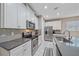 Bright kitchen with white cabinets, gray countertops, and subway tile backsplash at 12029 Tapestry Ln, Venice, FL 34293
