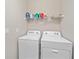 Laundry room with washer, dryer, and shelving at 12029 Tapestry Ln, Venice, FL 34293