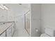 Bathroom featuring granite countertop vanity, glass-enclosed shower, and toilet at 12861 Oriago St, Venice, FL 34293