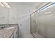 Bright bathroom featuring vanity with granite countertop and glass-enclosed shower at 12861 Oriago St, Venice, FL 34293