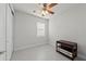 Bedroom with neutral walls, tiled floor, ceiling fan and a large window at 12861 Oriago St, Venice, FL 34293