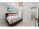Bright bedroom with a ceiling fan, large bed, and plenty of closet space at 12861 Oriago St, Venice, FL 34293