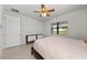 Well-lit bedroom featuring a large bed and window with blinds at 12861 Oriago St, Venice, FL 34293