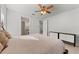 Spacious bedroom with ceiling fan and access to bathroom at 12861 Oriago St, Venice, FL 34293