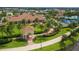 Aerial view of the community clubhouse, pool, and surrounding landscaping at 12861 Oriago St, Venice, FL 34293