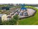 Aerial view of the community garden plots with tables, playground, and tennis courts at 12861 Oriago St, Venice, FL 34293