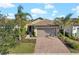 Single-story home with tile roof, attached garage, and landscaped yard at 12861 Oriago St, Venice, FL 34293