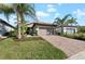 Single-story house with a brown garage door and a brick driveway at 12861 Oriago St, Venice, FL 34293
