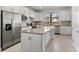 Modern kitchen with granite island and stainless steel appliances at 12861 Oriago St, Venice, FL 34293
