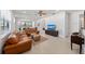 Spacious living room with leather sofas and a large TV at 12861 Oriago St, Venice, FL 34293