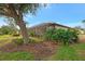 Landscaped backyard with spacious patio and lake view at 1375 Maseno Dr, Venice, FL 34292