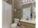Small bathroom with shower and patterned wallpaper at 1375 Maseno Dr, Venice, FL 34292
