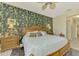 Spacious bedroom with wood furniture and patterned wallpaper at 1375 Maseno Dr, Venice, FL 34292