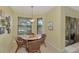 Bright breakfast nook with table and four chairs near sliding doors at 1375 Maseno Dr, Venice, FL 34292