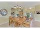 Bright dining room with a wood table and six chairs near entryway at 1375 Maseno Dr, Venice, FL 34292