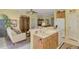 Open kitchen with breakfast bar and view into the living room at 1375 Maseno Dr, Venice, FL 34292