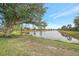 Tranquil lake view with homes and lush landscaping at 1375 Maseno Dr, Venice, FL 34292