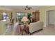 Living room with light beige sofas and access to a patio at 1375 Maseno Dr, Venice, FL 34292