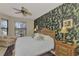 Spacious main bedroom with a large bed, ceiling fan, and accent wall at 1375 Maseno Dr, Venice, FL 34292