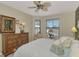 Bright main bedroom with a dresser and large window with golf course view at 1375 Maseno Dr, Venice, FL 34292